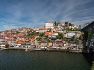 Fototapeta na wymiar Portugal, June 2019: Porto Cityscape over Douro River and medieval Ribeira district, Portugal. One of the oldest European centres, its historical core was proclaimed a World Heritage Site by UNESCO.