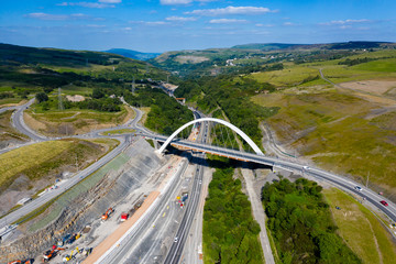 Aerial view of a new suspension bridge above roadworks (A465, Wales)