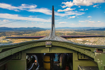 Above the fuselage of a B17 in flight looking at the tail