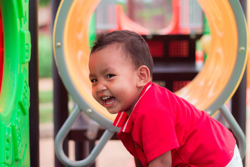 Happy asian child playing together on playground in park at thailand