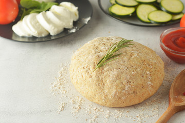 Composition with raw dought and fresh ingredients for pizza isolated on white background. Copy space. Flat lay food ingredients.