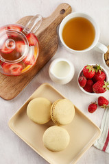 French strawberry pistachio macaron with berries tea. Afternoon tea still life