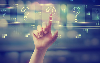 Question marks with hand pressing a button at night