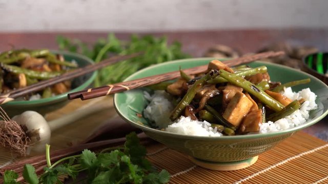 Closeup slide to the right of Szechuan green beans and tofu.