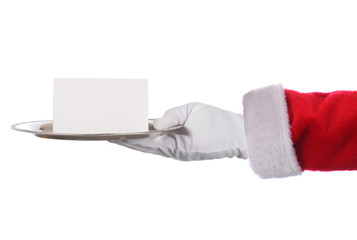 Santa Claus hand holding silver tray and blank note. Horizontal format arm with hand only.