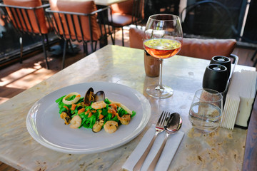 Pasta painted with organic paint, stuffed mussels, squid and rose wine