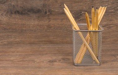 sketch pencils in basket on wooden table, design or engineering learning concept