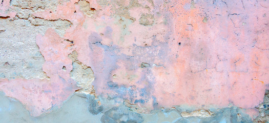 Old weathered painted wall background texture. Light grey blue pink dirty peeled plaster wall with falling off flakes of paint