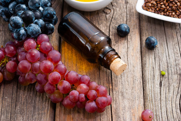 grape seed oil and grist on weathered wooden table