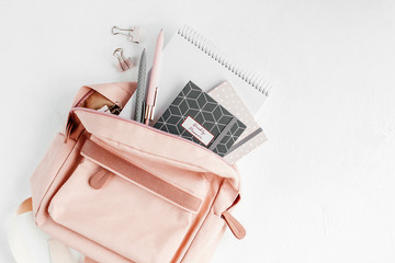 Backpack with school supplies and books for study. Back to school concept. Flat lay, top view