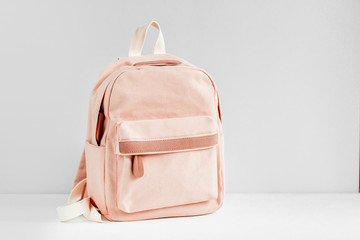Stylish pale pink Backpack on  with background. Flat lay, top view