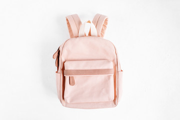Stylish pale pink Backpack on  with background. Flat lay, top view