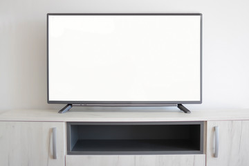  Smart Tv on light gray cabinet with white blank screen.  Mockup TV concept.