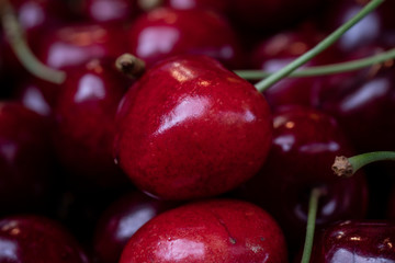 Basket of ripe sweet cherries as a background