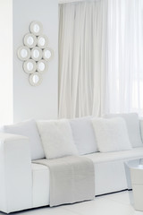 Interior of the living room of the hotel. Beautiful living room with white sofa. White Concept Living Room Interior. Modern bed room interior in Luxury villa. White colours, big window