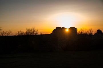 sunset over field. Old fortress 