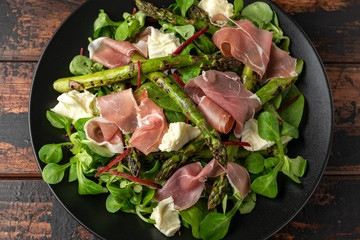 Grilled Asparagus, parma ham salad with mozzarella cheese and green vegetables