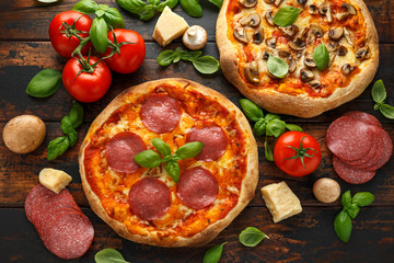 Homemade Pepperoni, Salami, mushroom Pizza with basil, tomatoes, cheese on wooden table. ready to eat