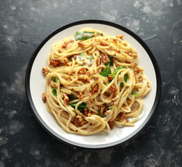 Pasta with roasted walnut, ricotta white pesto sauce, parmesan cheese and spinach