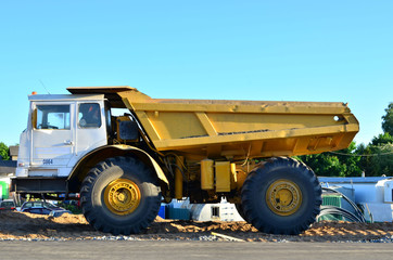 Big yellow dump truck working on the construction site - Image