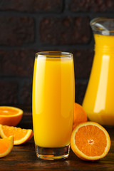 Orange juice in glass on rustic wooden table