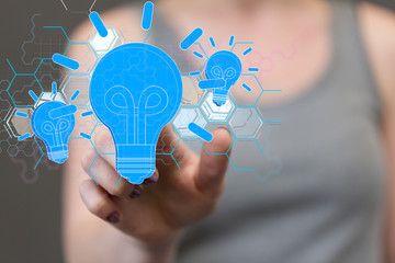  holding illuminated light bulb, idea, innovation and inspiration concept.