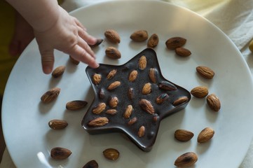 Homemade chocolate with almond in hand