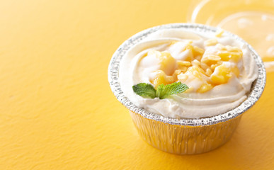 Summer fruit dessert is Mango cheesecake on yellow table background