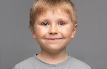 Portrait of happy smiling boy. Attractive kid in studio.