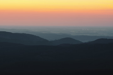 Obraz premium Mountain nature landscape panorama with silhouette layers and valley view at sunset colorful sky. Wolfswarte, Torfhaus, National Park Harz in Germany