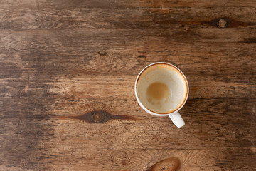 Closeup of Empty white coffee's cup after drink on wooden table