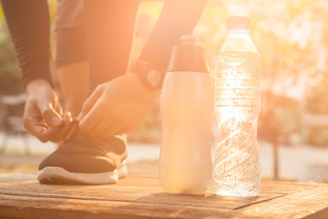 Man in a park and bottle of water with smartwatch