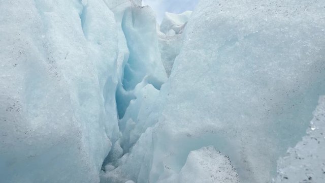 White ice inside of a glacier in an ice cave. Steadycam shot, 4K