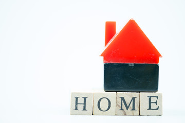 Red toy home put on wooden block with HOME
