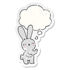 cute cartoon rabbit and thought bubble as a distressed worn sticker