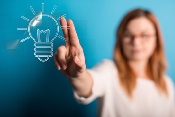  holding illuminated light bulb, idea, innovation and inspiration concept.