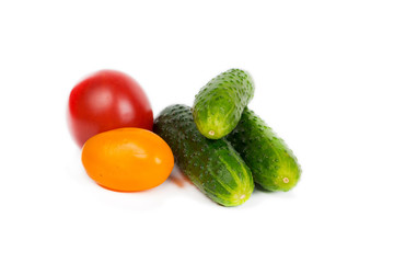 fresh tomatoes and cucumbers isolated on white background