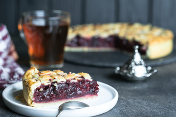 Homemade delicious cherry pie on a dark background.