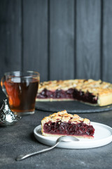 Homemade delicious cherry pie on a dark background copy space..
