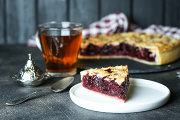 Homemade delicious cherry pie on a dark background.