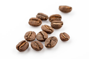 Coffee grains isolated on white background. Top view at an angle. For design.