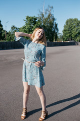 young and smiling girl is actively moving on a Sunny summer day. a woman with sunglasses on her...