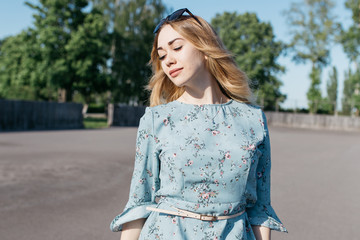 young and smiling girl is actively moving on a Sunny summer day. a woman with sunglasses on her...