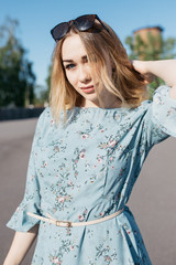 young and smiling girl is actively moving on a Sunny summer day. a woman with sunglasses on her...