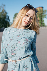 young and smiling girl is actively moving on a Sunny summer day. a woman with sunglasses on her...