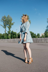 young and smiling girl is actively moving on a Sunny summer day. a woman with sunglasses on her...