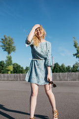 young and smiling girl is actively moving on a Sunny summer day. a woman with sunglasses on her...