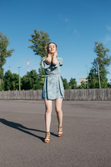 young and smiling girl is actively moving on a Sunny summer day. a woman with sunglasses on her...