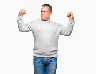 Fototapeta premium Middle age arab man wearing sport sweatshirt over isolated background showing arms muscles smiling proud. Fitness concept.