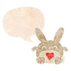 cute cartoon rabbit with love heart and speech bubble in retro textured style